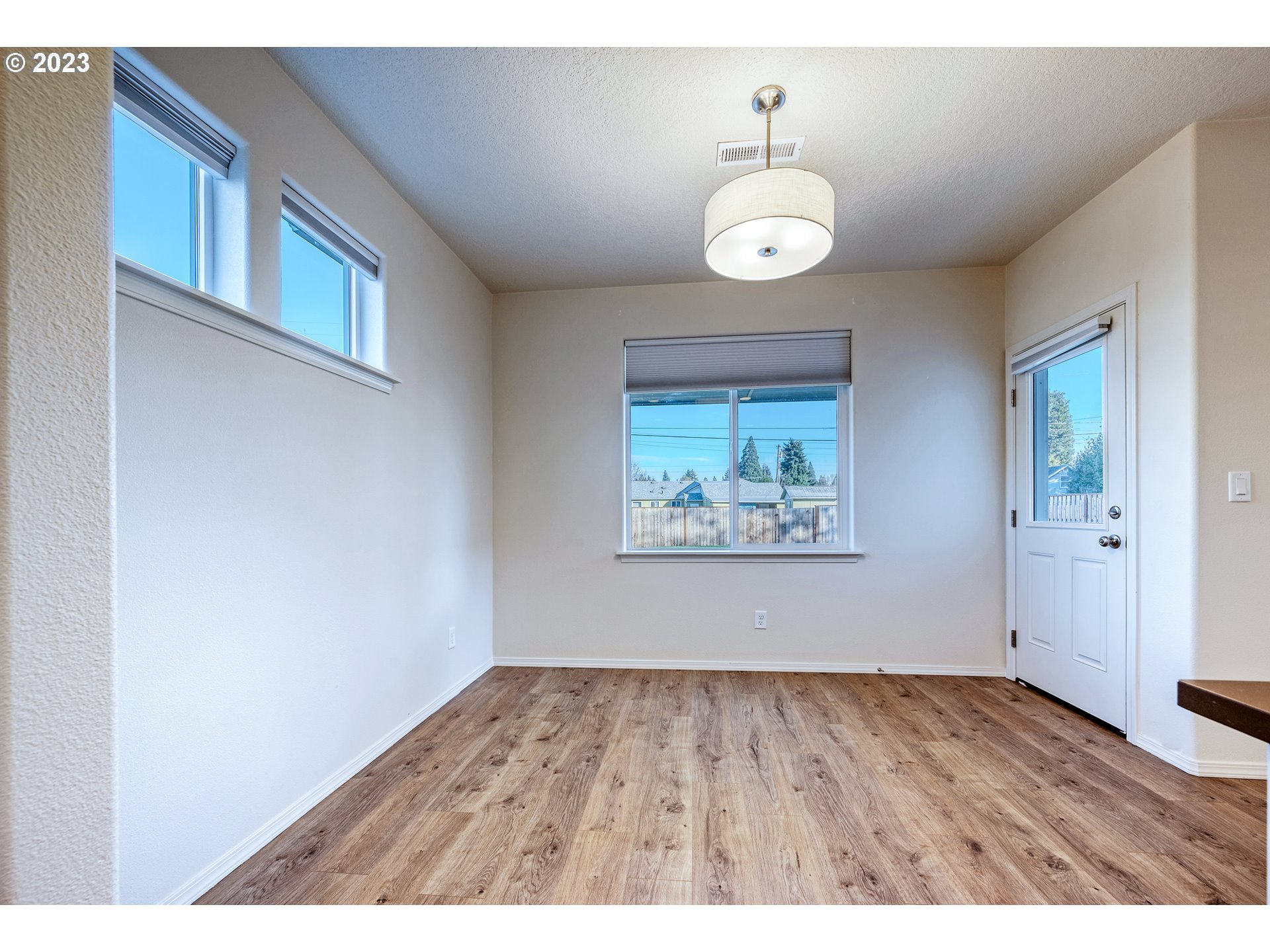 1057 Laura Street Springfield, OR 97477 - Photo 13 of 39 a view of an empty room with wooden floor and a window