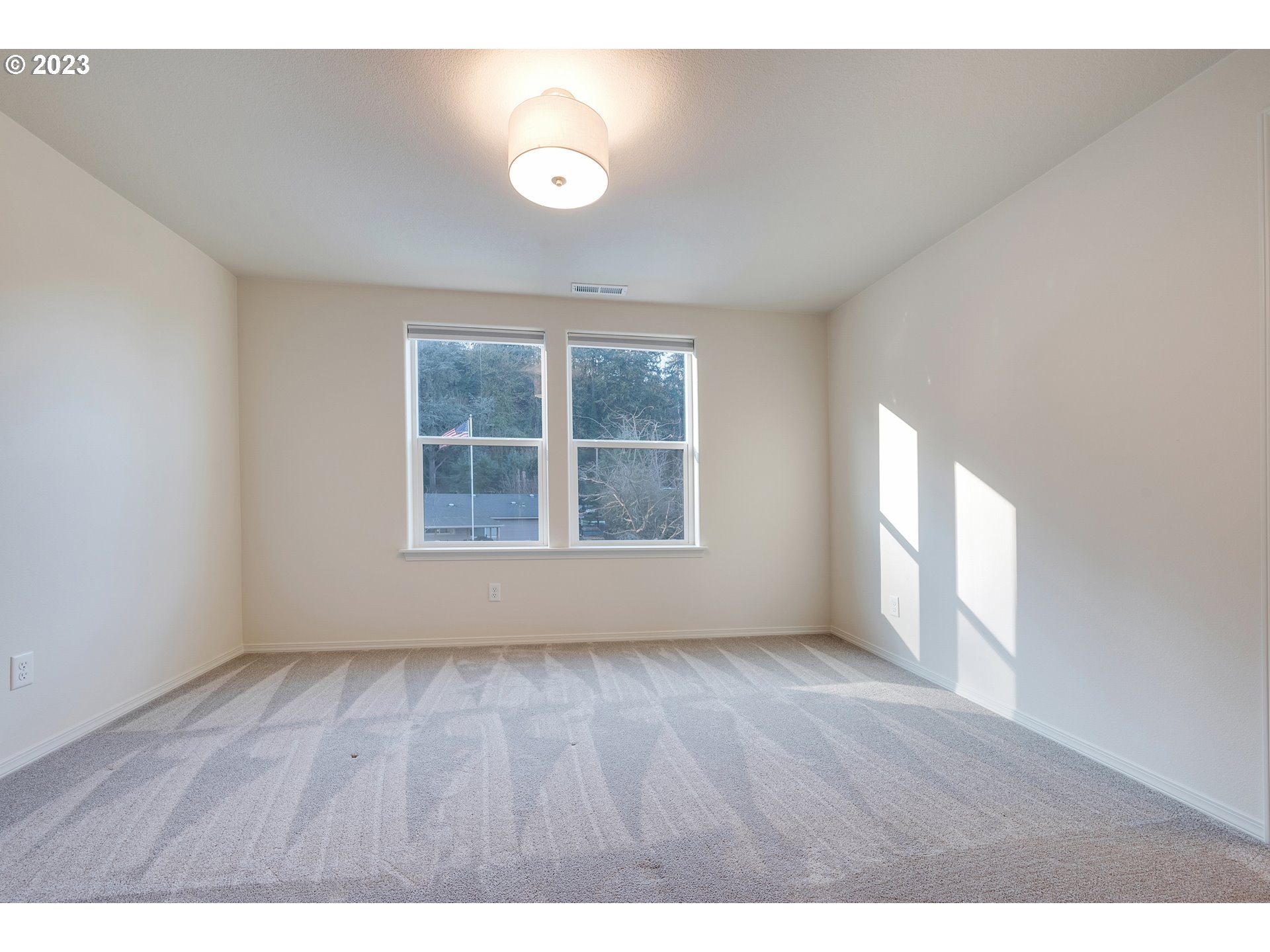 1057 Laura Street Springfield, OR 97477 - Photo 23 of 39 a view of an empty room with wooden floor and a window