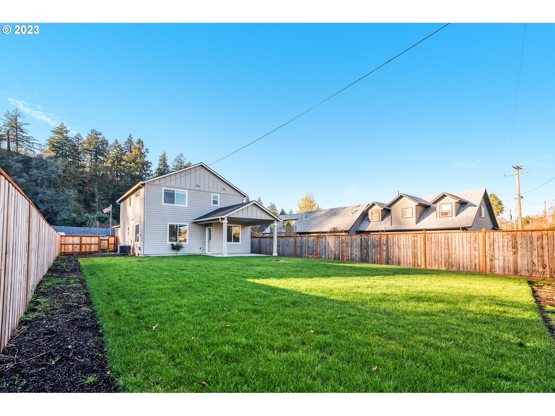 1057 Laura Street Springfield, OR 97477 - Photo 27 of 39 a view of a big house with a big yard and large trees