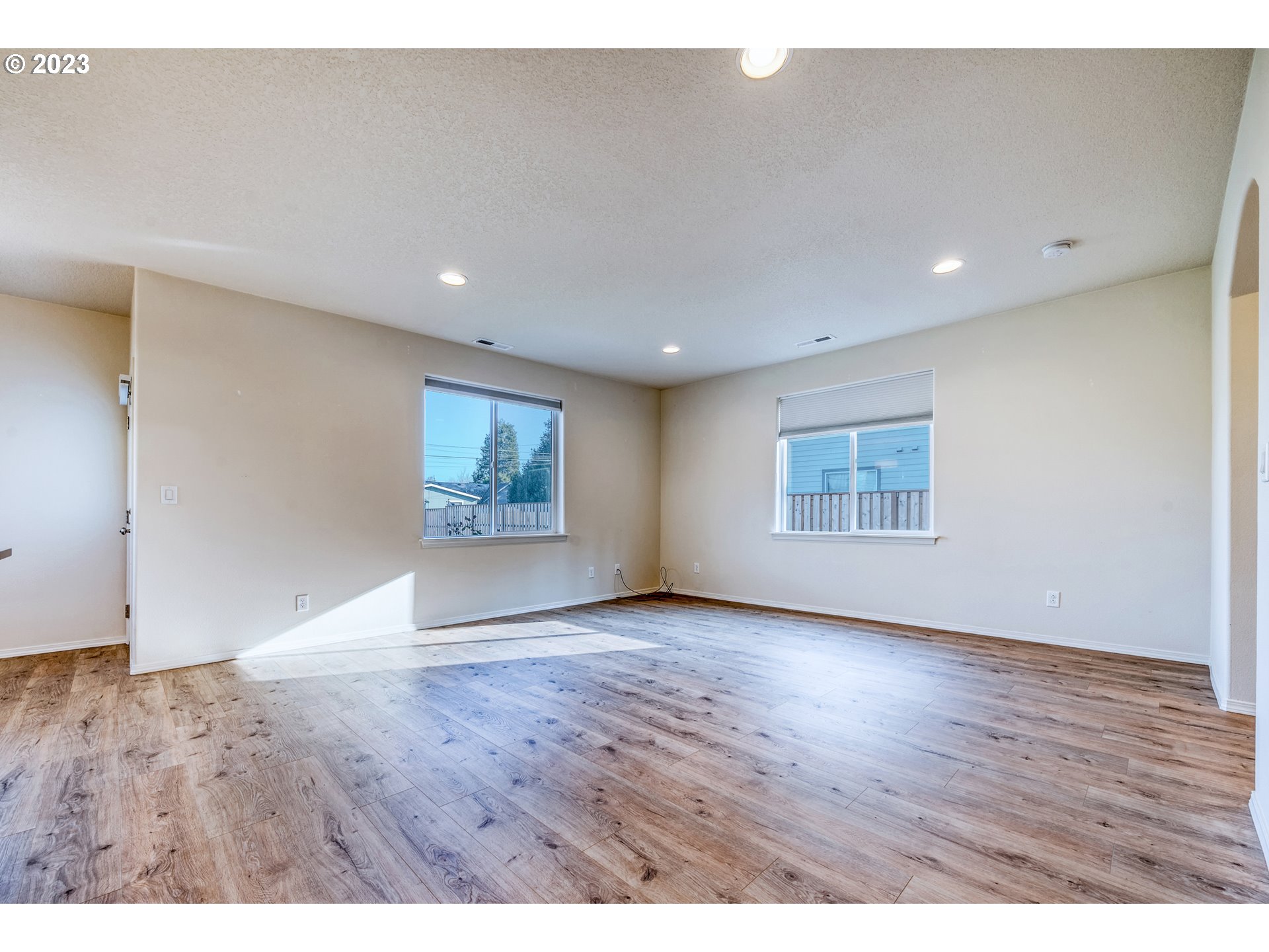 1057 Laura Street Springfield, OR 97477 - Photo 5 of 39 an empty room with wooden floor and windows