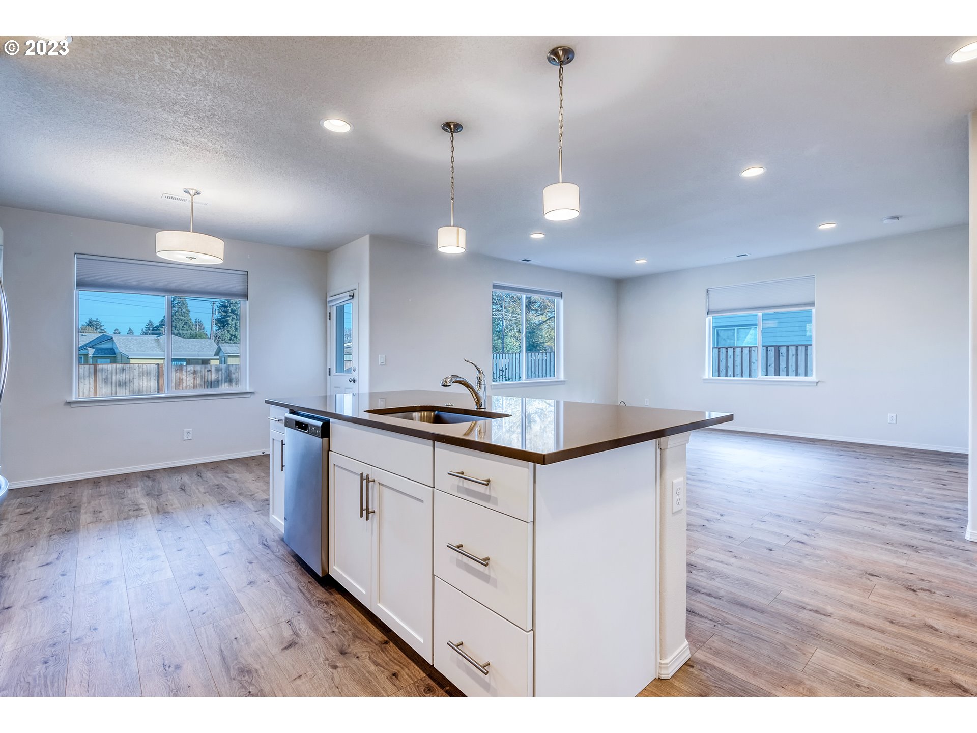 1057 Laura Street Springfield, OR 97477 - Photo 8 of 39 a kitchen with granite countertop a stove a sink a window and wooden floor