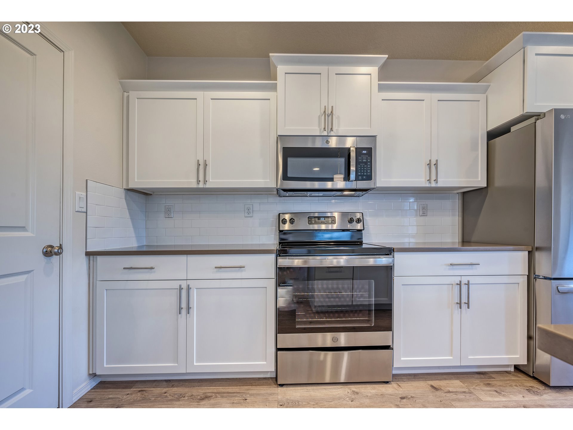 1057 Laura Street Springfield, OR 97477 - Photo 9 of 39 a kitchen with stainless steel appliances granite countertop a stove microwave and cabinets