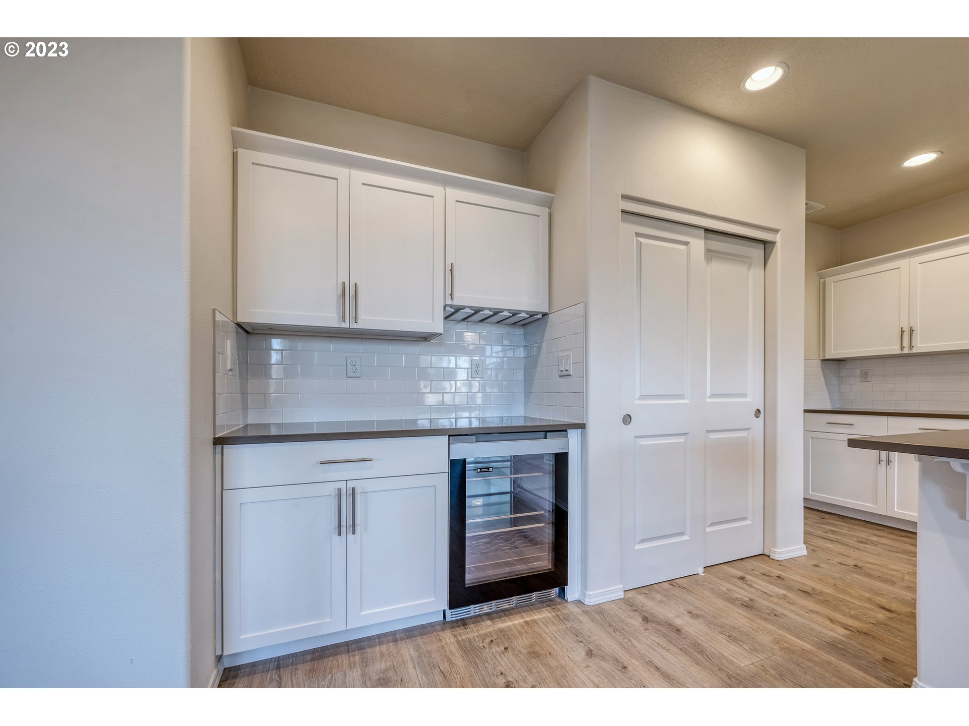 1057 Laura Street Springfield, OR 97477 - Photo 10 of 39 a kitchen with granite countertop white cabinets and white appliances