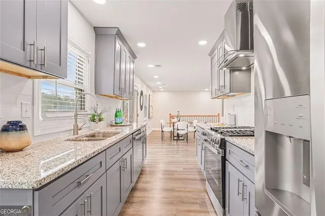 a kitchen with sink stove and cabinets