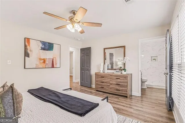 a en suite bathroom with a granite countertop sink and a mirror