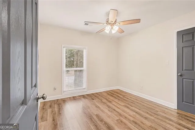 a living room with furniture a rug and a flat screen tv