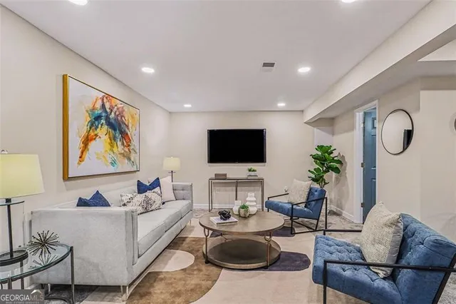 a living room with furniture kitchen view and a large window
