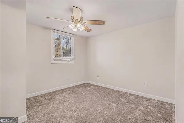 a bathroom with a granite countertop sink and a toilet
