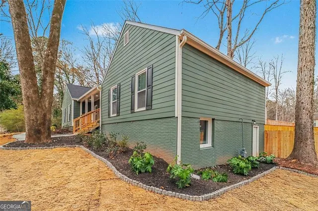 a view of a house with a yard covered in snow