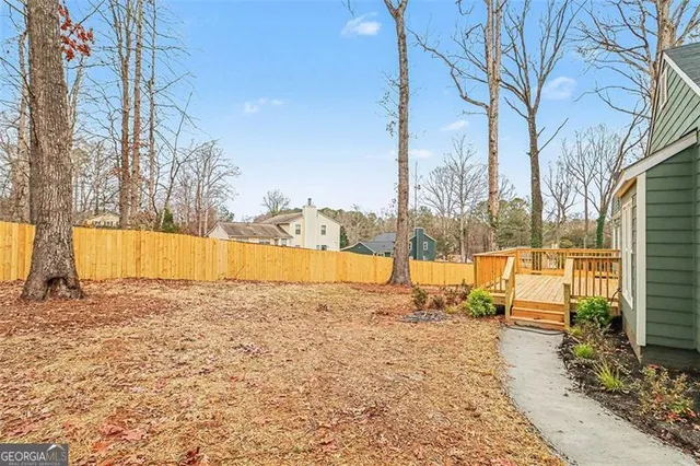 a view of a backyard with plants and a lake view
