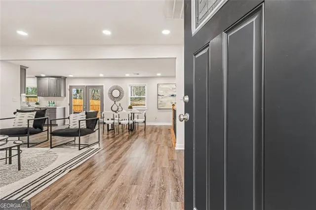 a living room with furniture and wooden floor