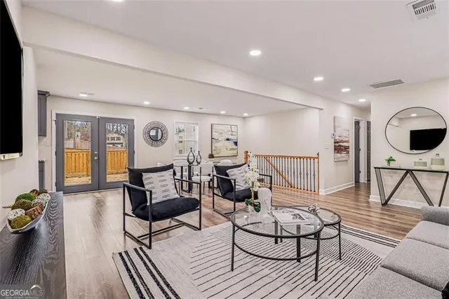 a living room with furniture and kitchen view