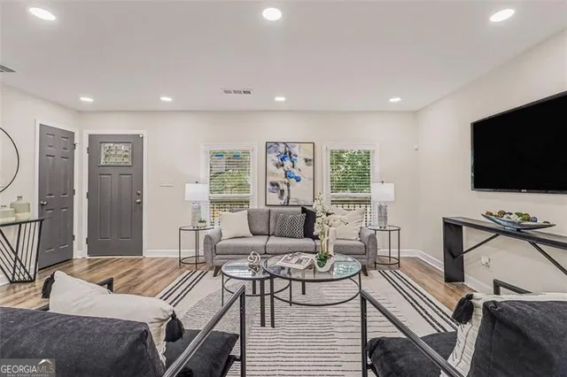 a living room with furniture and a flat screen tv