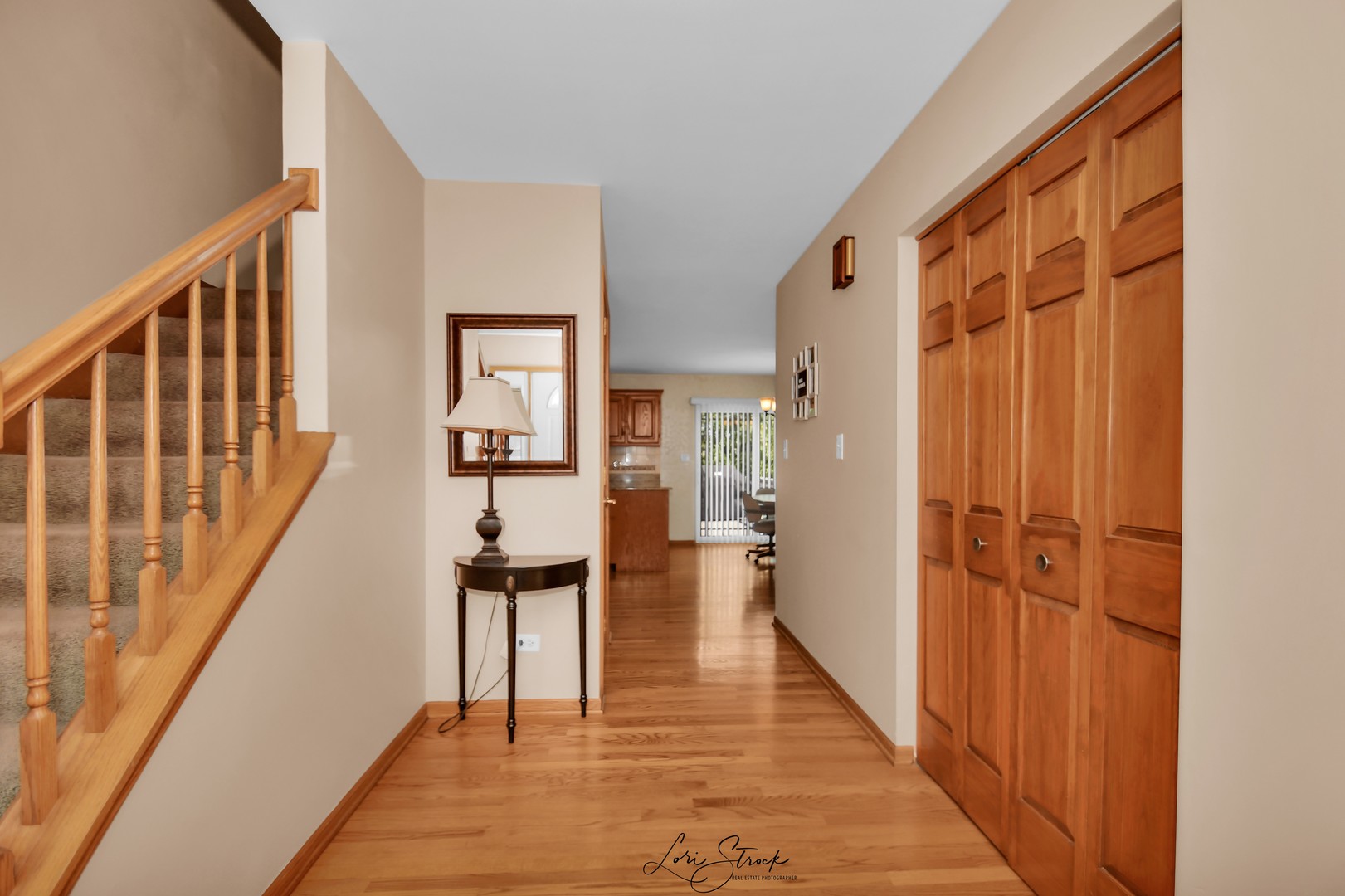 19407 Cherry Street Mokena, IL 60448 - Photo 9 of 33 a view of a hallway with wooden floor and staircase