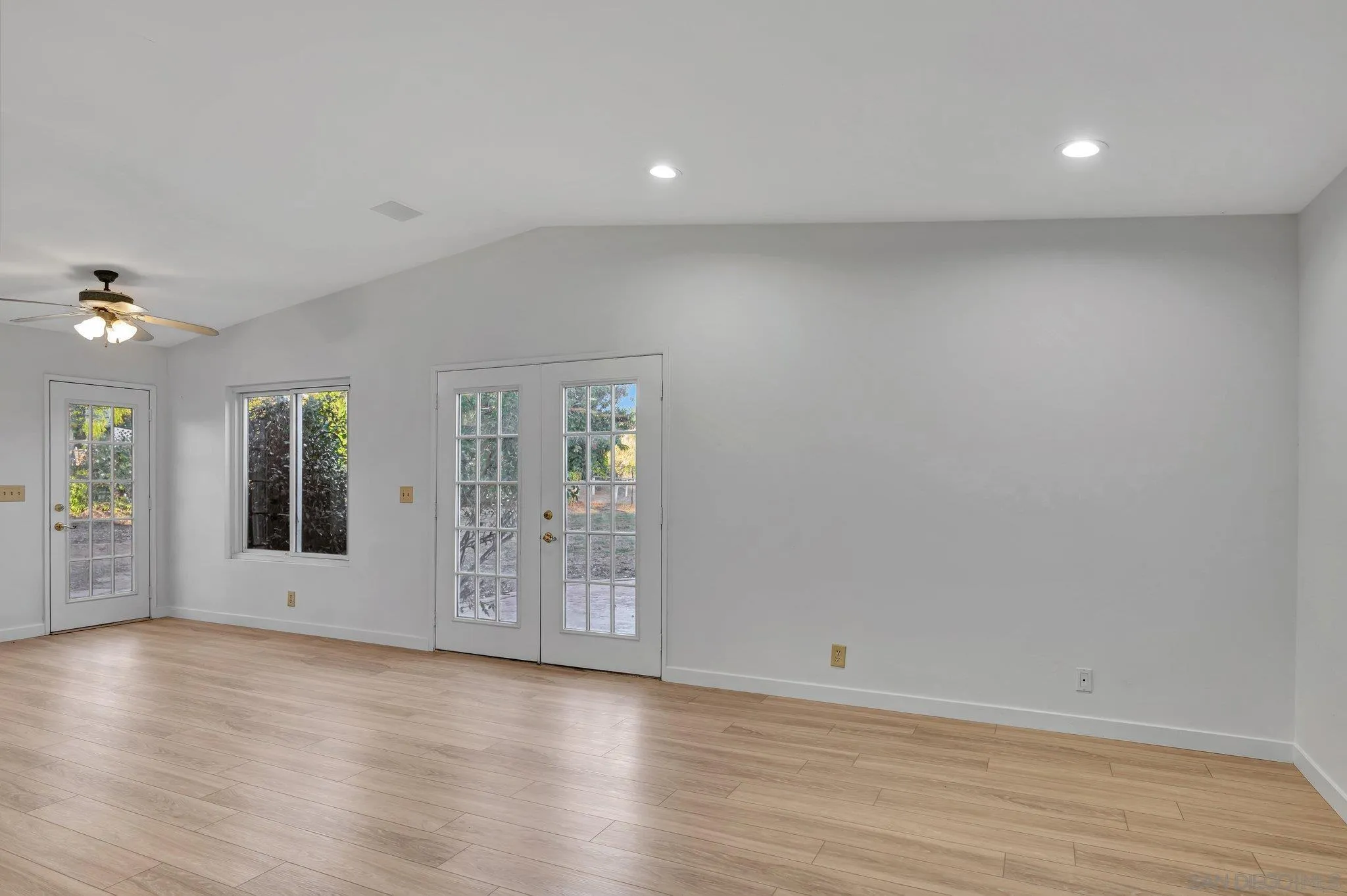 13455 Olive Tree Lane Poway, CA 92064 - Photo 11 of 36 an empty room with wooden floor and windows