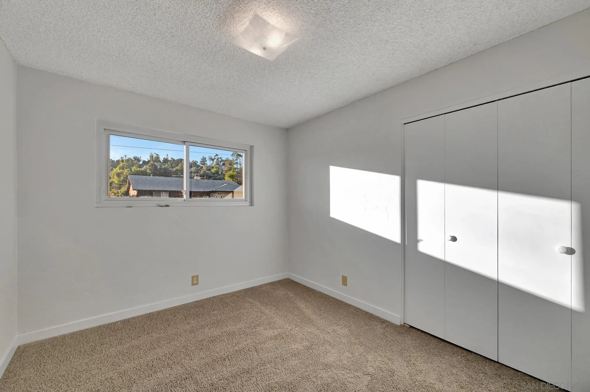 13455 Olive Tree Lane Poway, CA 92064 - Photo 22 of 36 a view of an empty room with a window