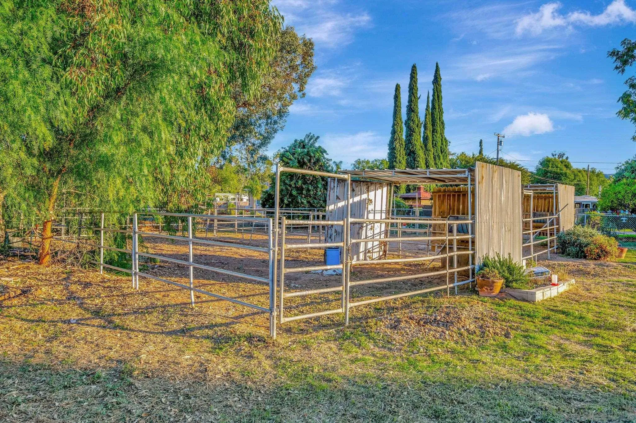 13455 Olive Tree Lane Poway, CA 92064 - Photo 31 of 36 a view of a backyard with floor to ceiling window and wooden fence