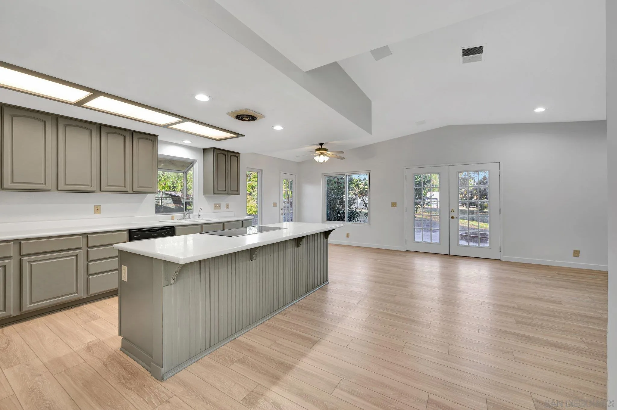 13455 Olive Tree Lane Poway, CA 92064 - Photo 6 of 36 a large kitchen with stainless steel appliances granite countertop a lot of counter space and wooden floors