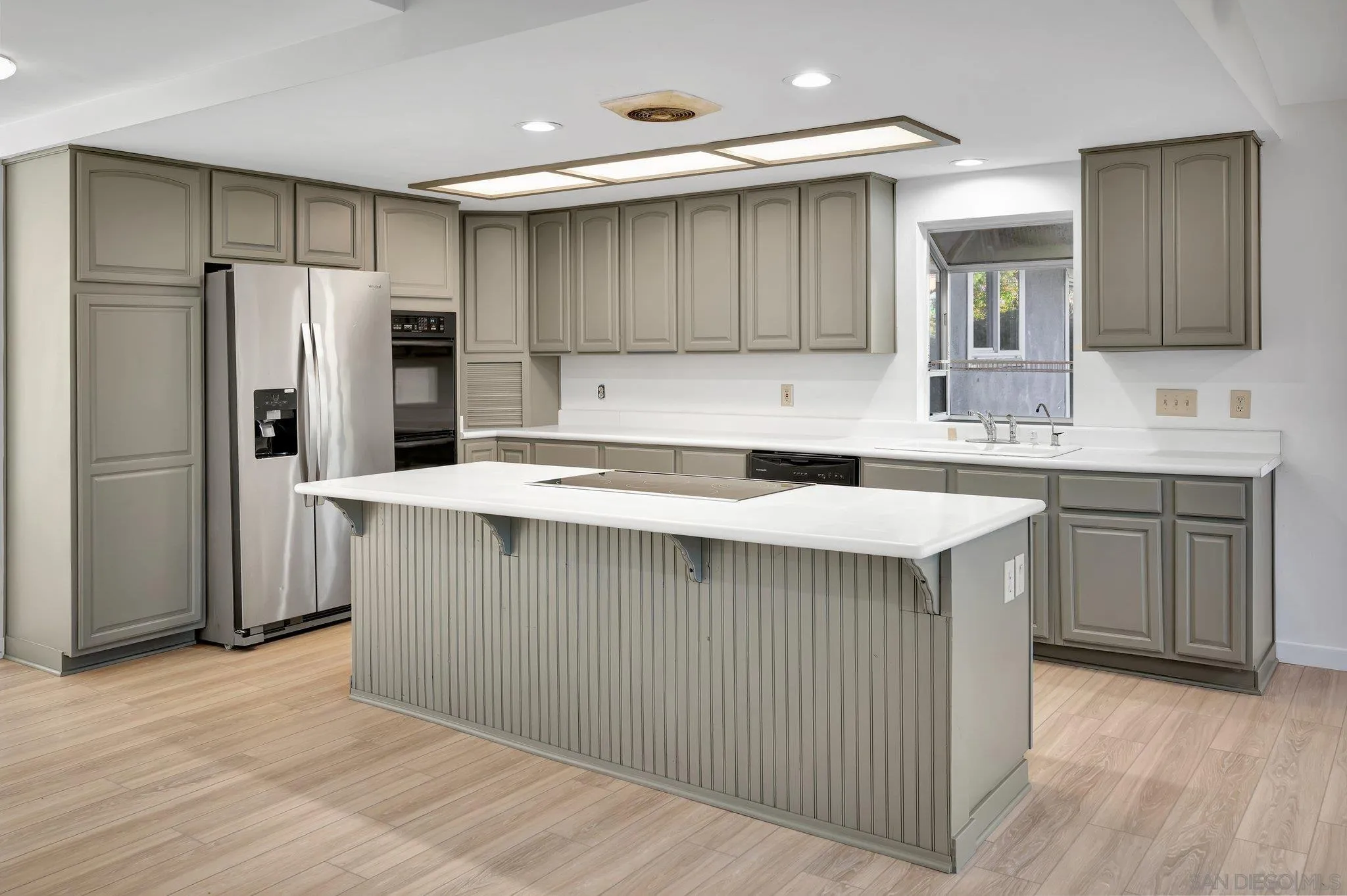 13455 Olive Tree Lane Poway, CA 92064 - Photo 7 of 36 a kitchen with stainless steel appliances a sink stove and refrigerator