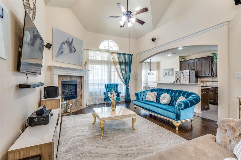 1324 Needle Cactus Drive Fort Worth, TX 76177 - Photo 11 of 36 a living room with furniture a fireplace and a flat screen tv