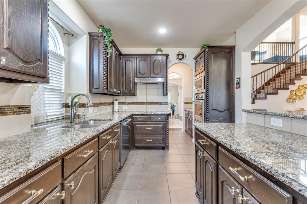 1324 Needle Cactus Drive Fort Worth, TX 76177 - Photo 13 of 36 a kitchen with granite countertop a sink and cabinets