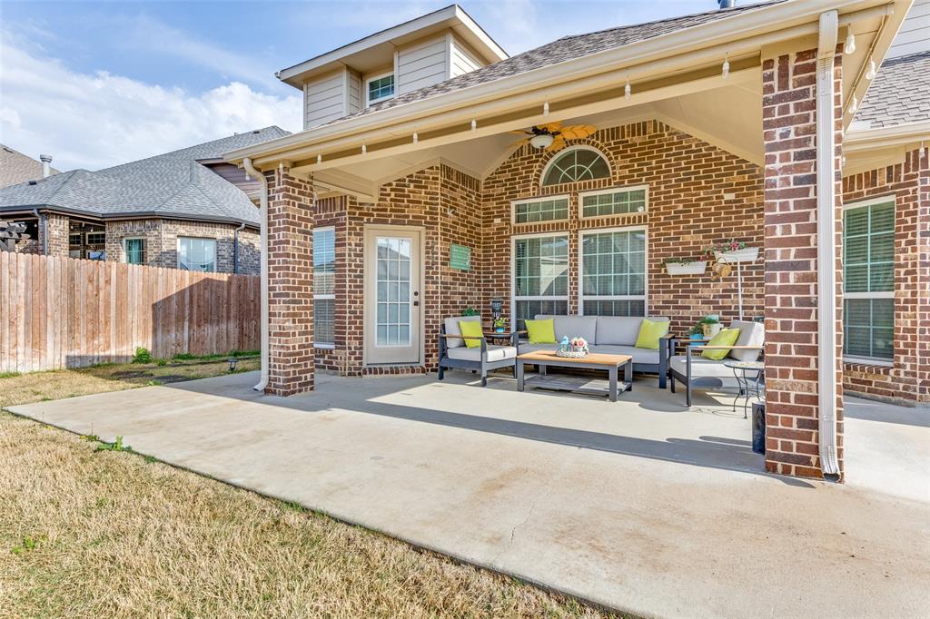1324 Needle Cactus Drive Fort Worth, TX 76177 - Photo 34 of 36 a view of a patio with a table and chairs and wooden fence