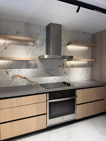 a stove top oven sitting inside of a kitchen