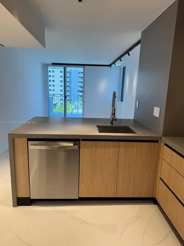 a kitchen with stainless steel appliances granite countertop a sink and a stove