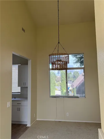 a view of a room that has a window and a table
