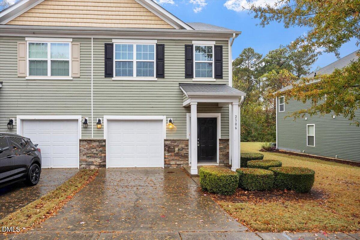 a front view of a house with a yard and garage