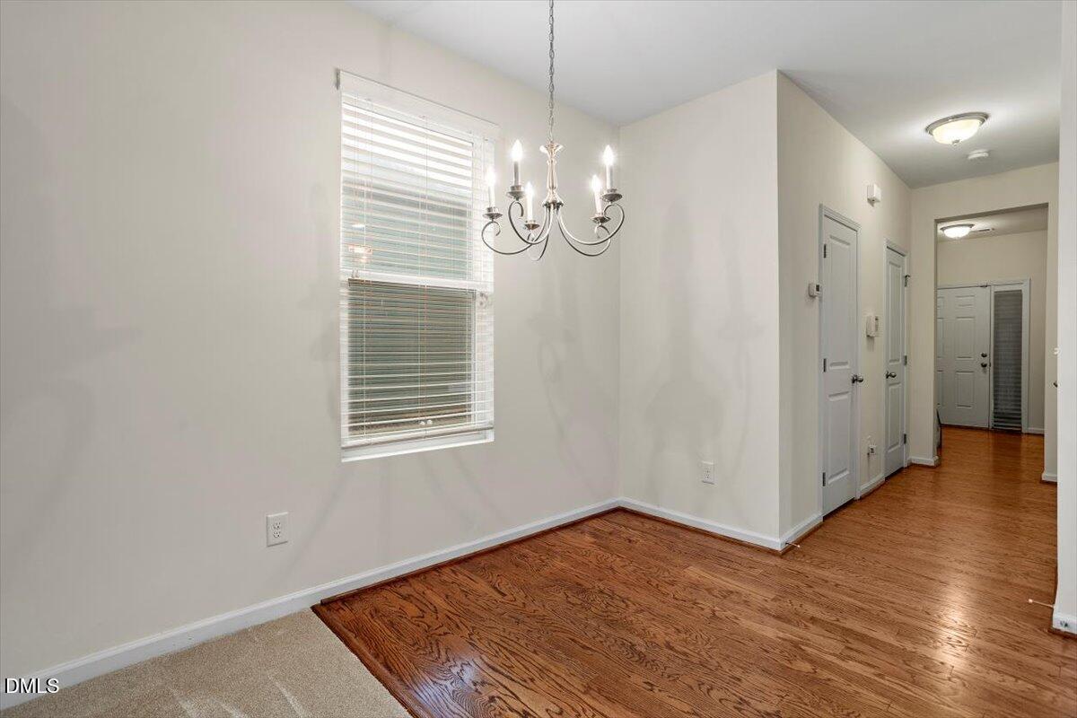 2306 Stoney Spring Drive Raleigh, NC 27610 - Photo 9 of 36 a view of an empty room with wooden floor and a window