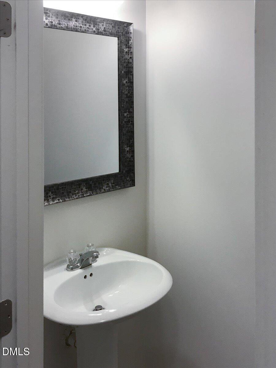 2306 Stoney Spring Drive Raleigh, NC 27610 - Photo 14 of 35 a bathroom with a sink and a mirror