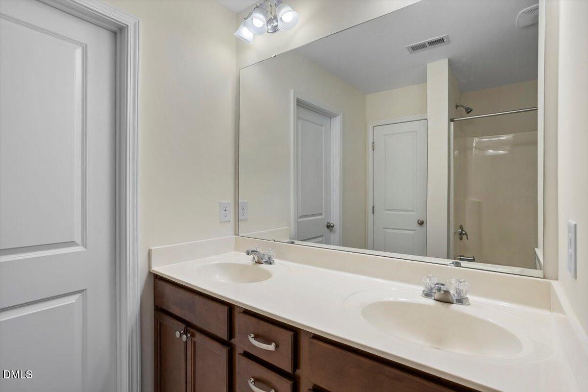2306 Stoney Spring Drive Raleigh, NC 27610 - Photo 19 of 35 a bathroom with a sink and a mirror