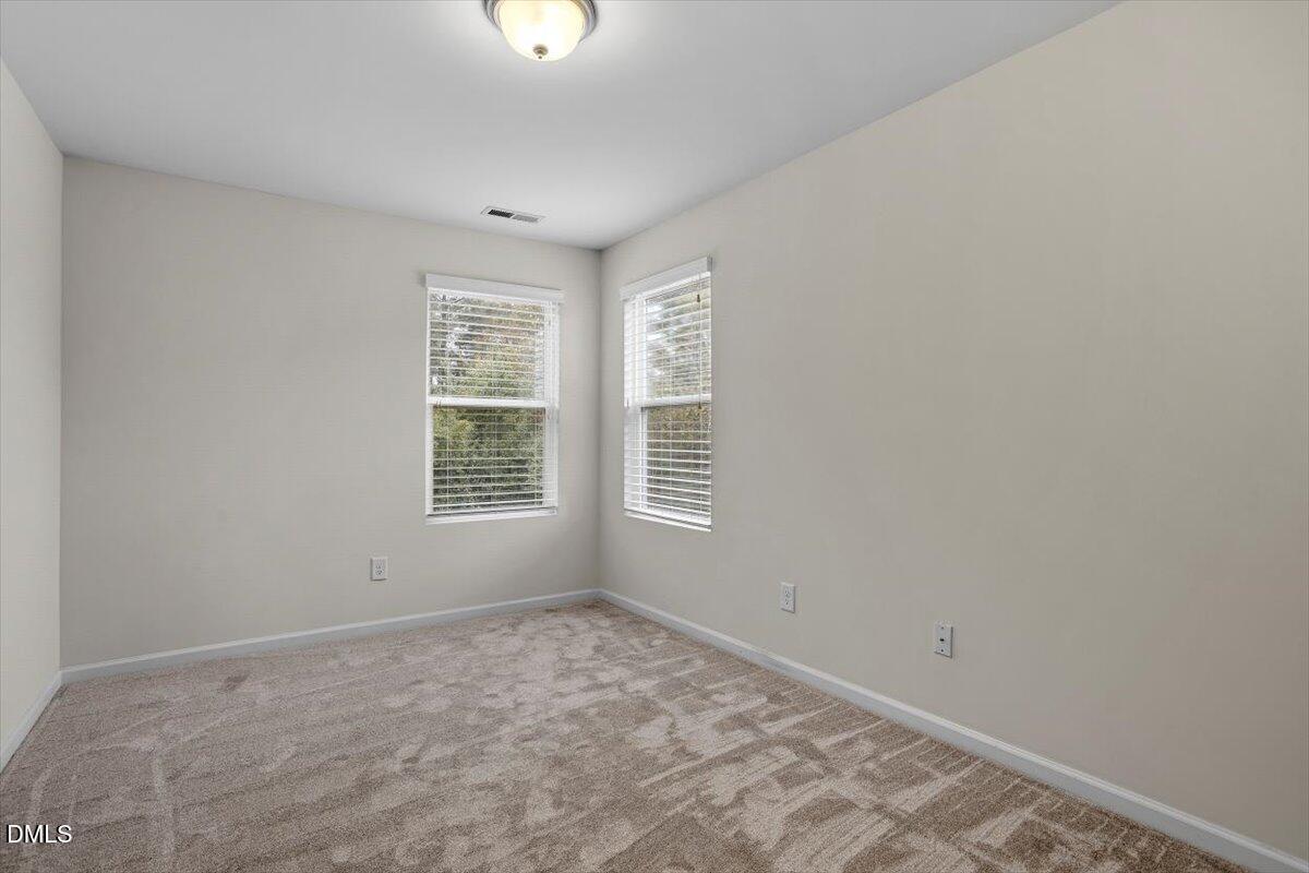 2306 Stoney Spring Drive Raleigh, NC 27610 - Photo 21 of 35 a view of a big room with windows and chandelier fan