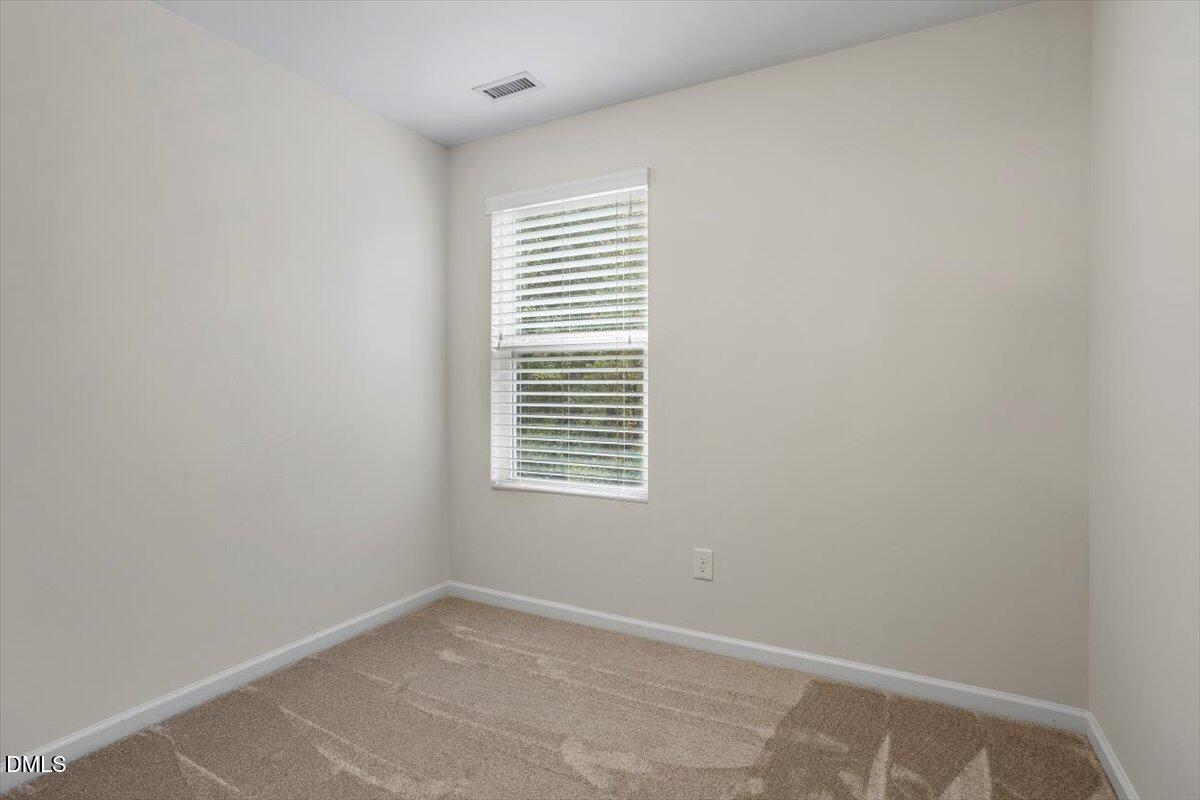 2306 Stoney Spring Drive Raleigh, NC 27610 - Photo 23 of 35 an empty room with a window