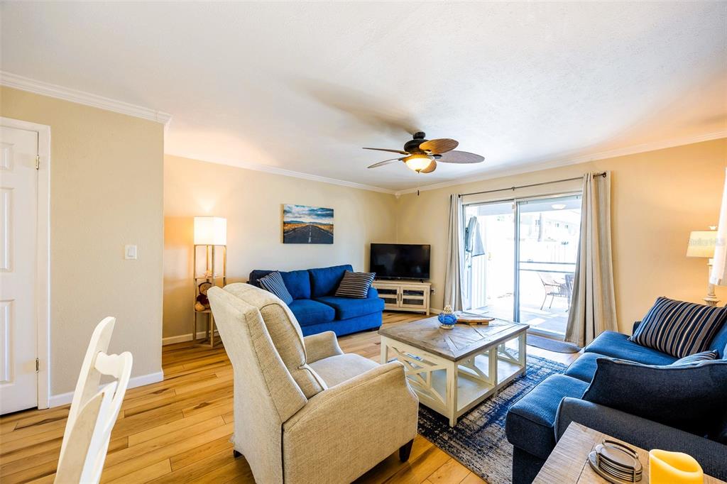 6777 Winkler Road, Unit 150 Fort Myers, FL 33919 - Photo 12 of 48 a living room with furniture and a flat screen tv