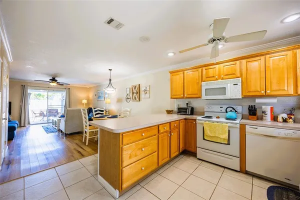 a kitchen with stainless steel appliances granite countertop a sink dishwasher stove top oven and cabinets