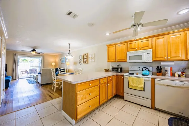 a kitchen with stainless steel appliances granite countertop a sink dishwasher stove top oven and cabinets