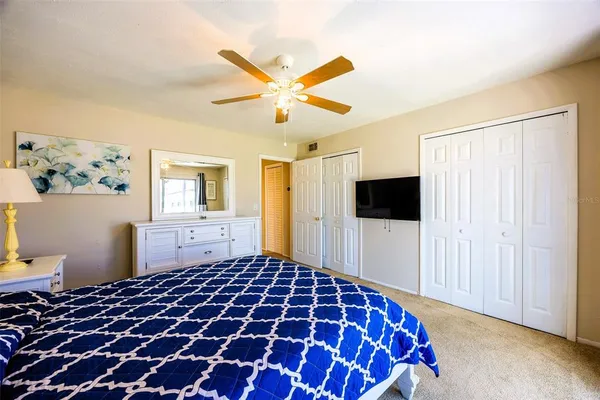 a bedroom with a bed and a television