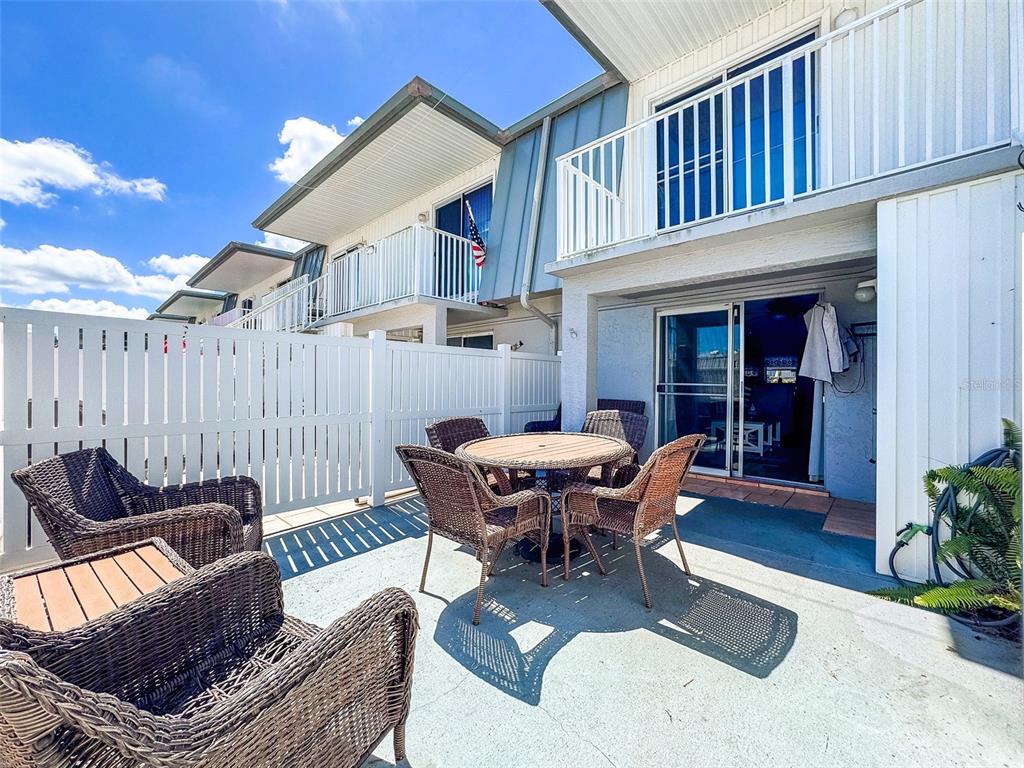 6777 Winkler Road, Unit 150 Fort Myers, FL 33919 - Photo 27 of 48 a view of a patio with couches table and chairs and potted plants