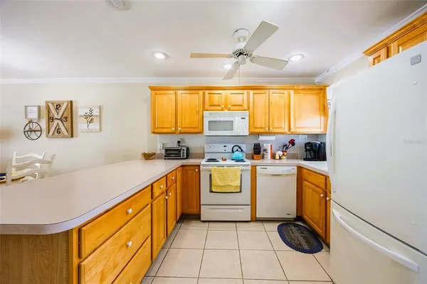 a kitchen with a sink appliances cabinets and a window