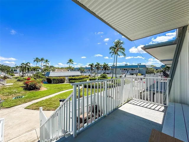 a view of a balcony with yard