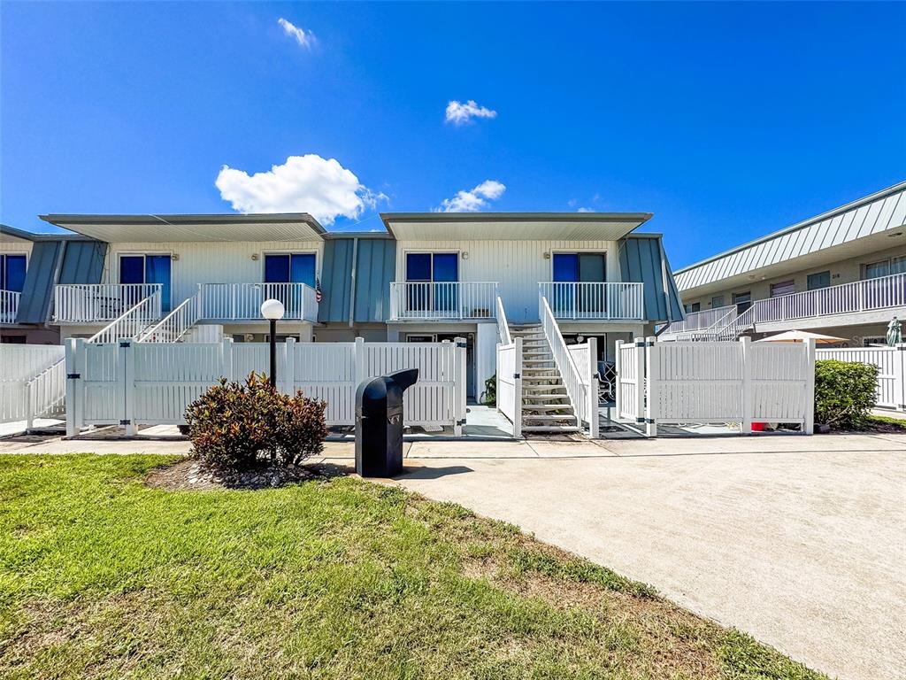6777 Winkler Road, Unit 150 Fort Myers, FL 33919 - Photo 32 of 48 a front view of a house with a yard