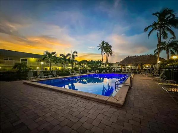 a view of a swimming pool with outdoor seating