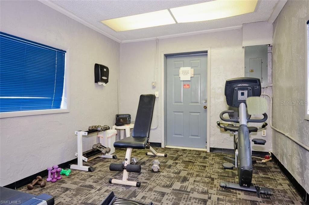 6777 Winkler Road, Unit 150 Fort Myers, FL 33919 - Photo 40 of 48 a room with gym equipment and wooden floor