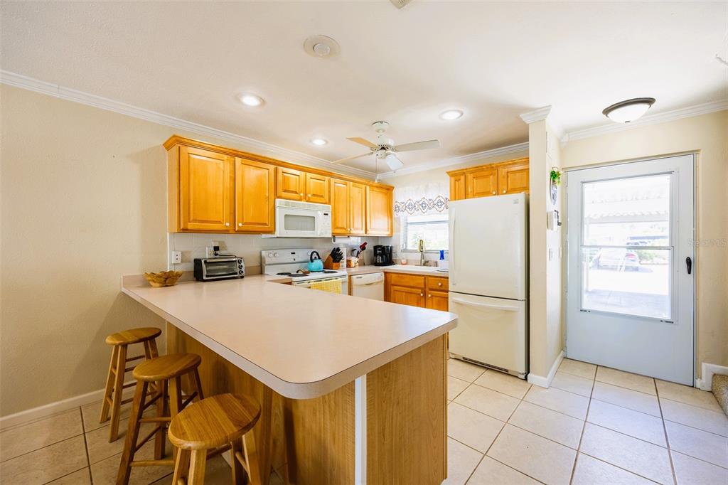 6777 Winkler Road, Unit 150 Fort Myers, FL 33919 - Photo 4 of 48 a kitchen with a refrigerator a stove a sink and a refrigerator