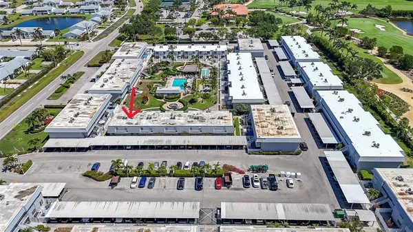 an aerial view of a house with garden space and lake view