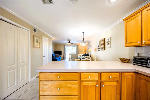 a view of a kitchen with kitchen island a sink wooden floor and counter top space