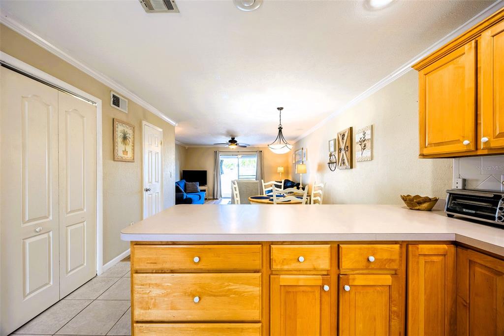 6777 Winkler Road, Unit 150 Fort Myers, FL 33919 - Photo 6 of 48 a view of a kitchen with kitchen island a sink wooden floor and counter top space