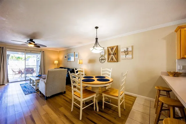 a dining room with furniture and wooden floor